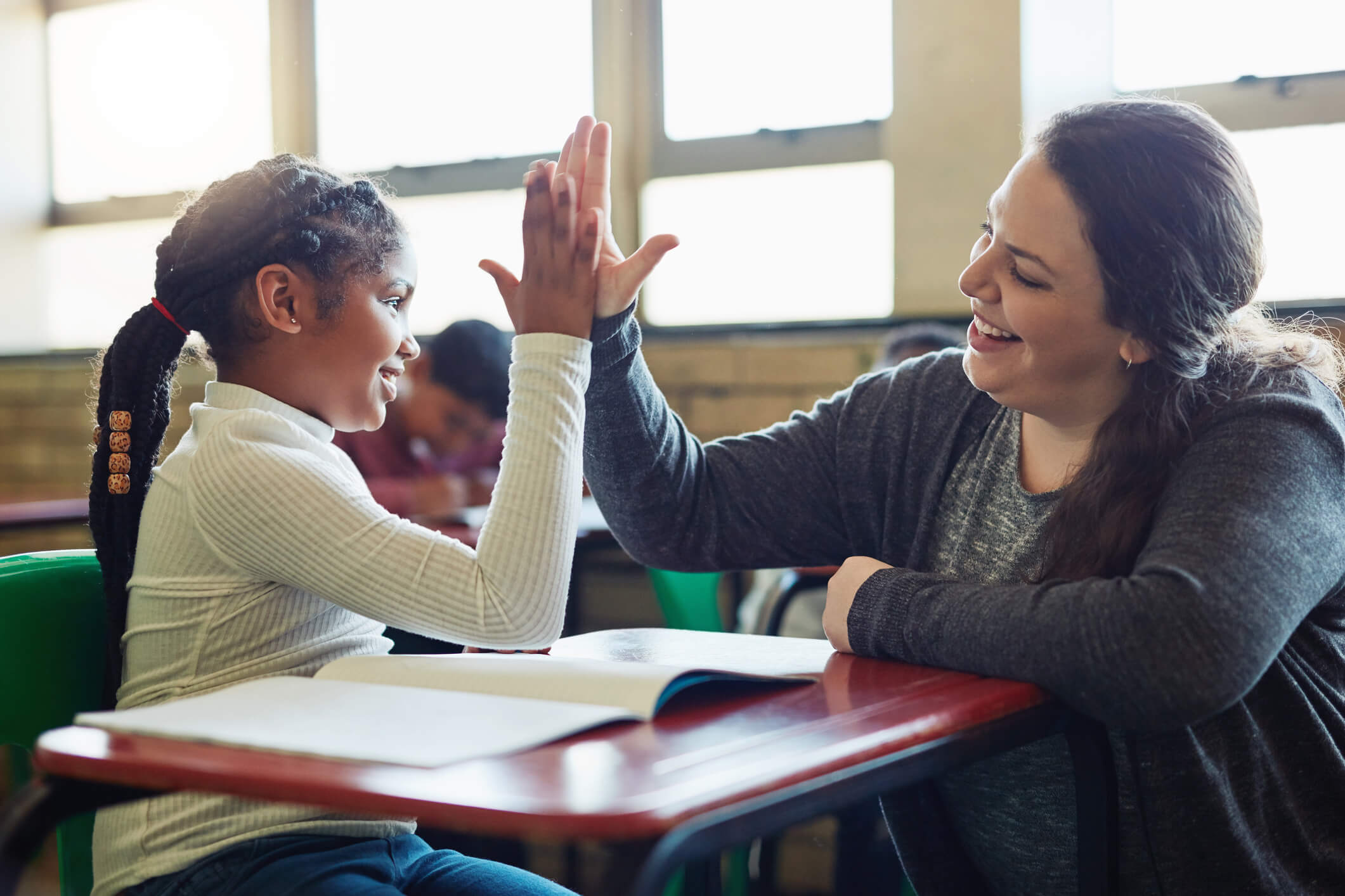 Teacher and student high-fiving.