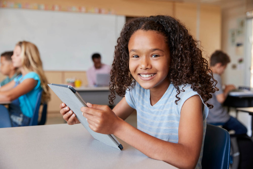 A young student completes a bite-sized learning lesson on a tablet.