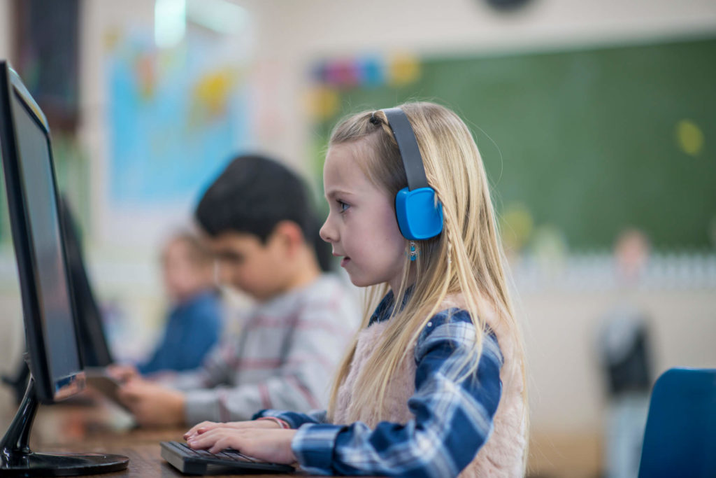 A young student listens to a podcast as part of bite-sized learning.