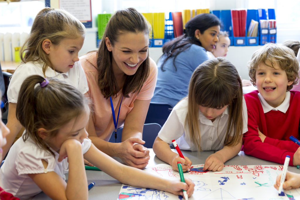 Students work with their teacher on a bite-sized lesson in class.