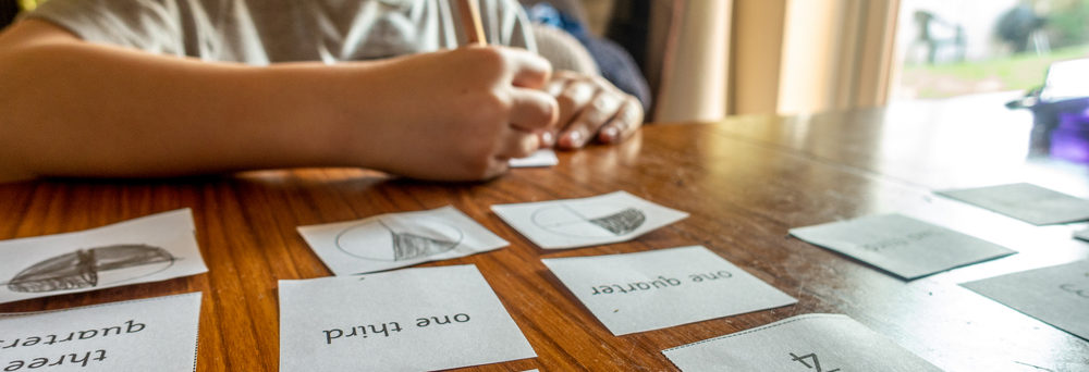 A boy practices math facts with flash cards.
