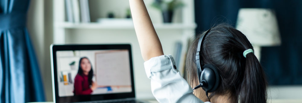 A student raises her hand during virtual learning.