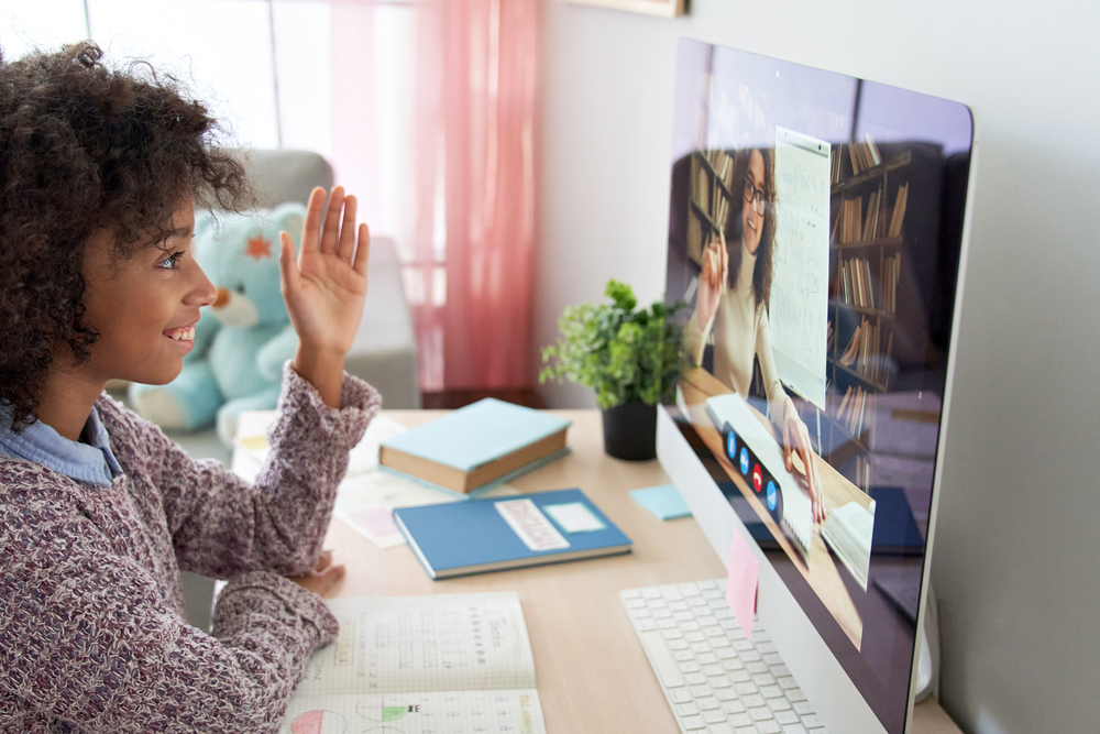 A student speaks with their teacher during a remote learning class.