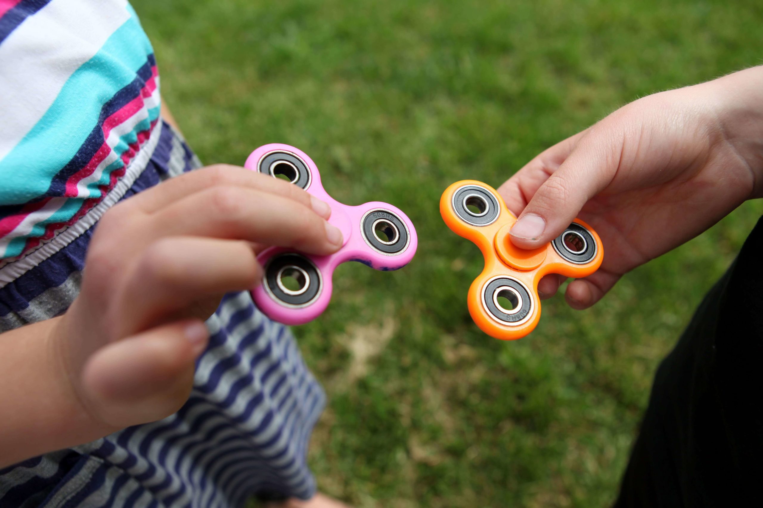 Students playing with fidget spinners.