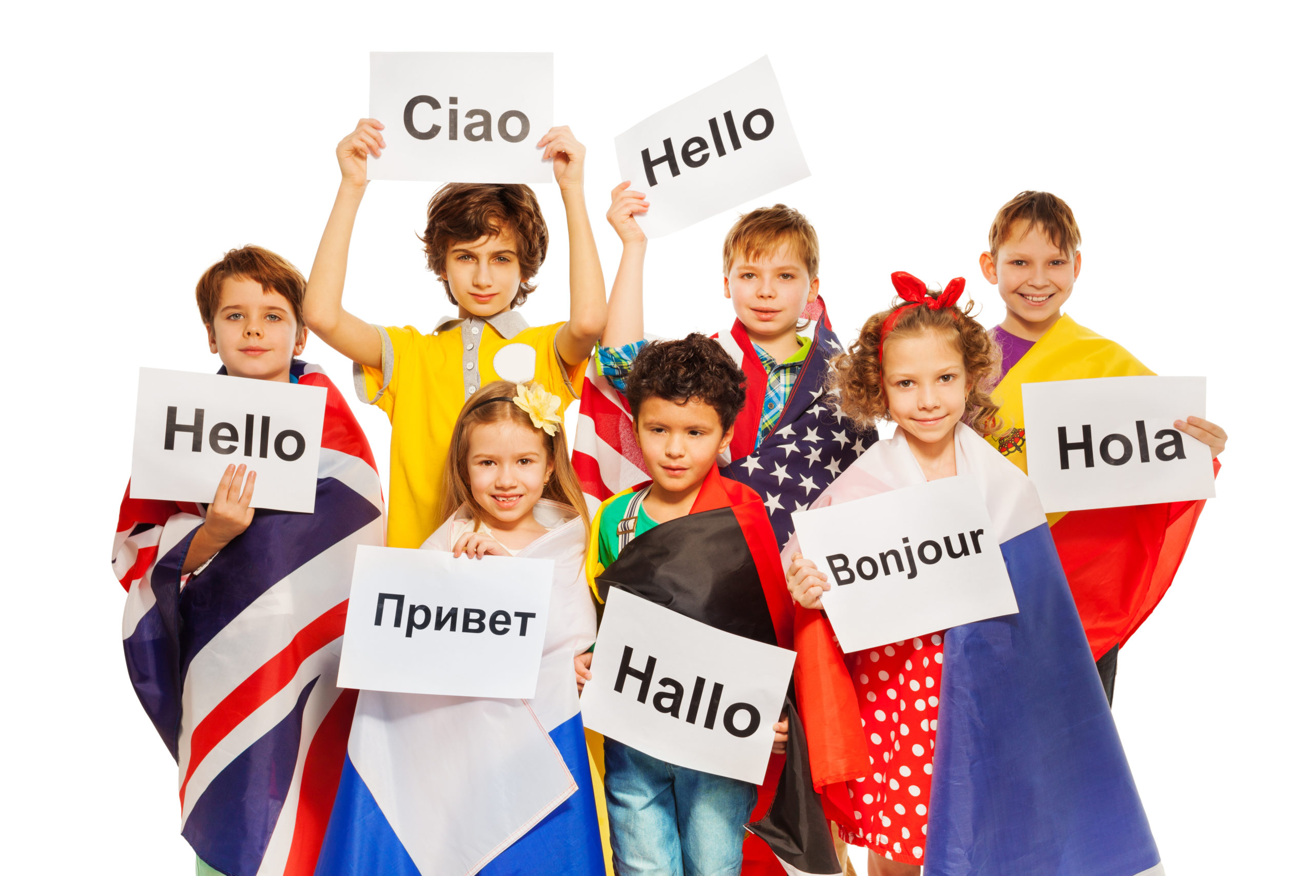 A group of students wearing flags and holding signs that say hello in their native language.