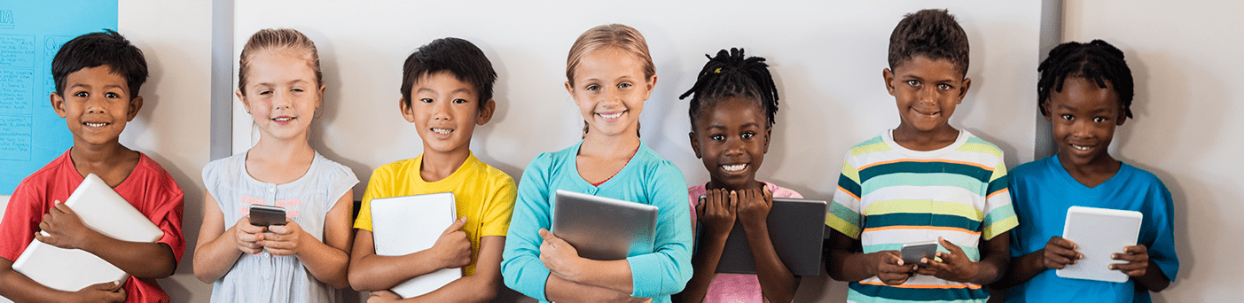 Group of seven boys and girls holding various electronic devices.