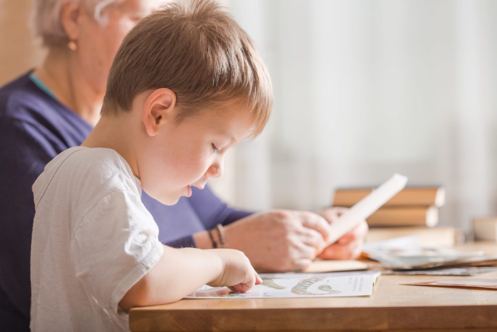 Young student working with his teacher.
