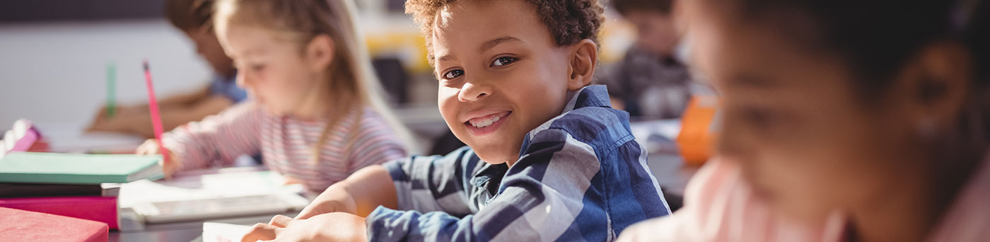 A smiling boy at school.
