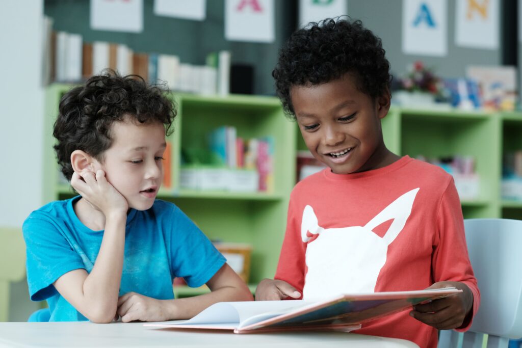 Two elementary students reading together.