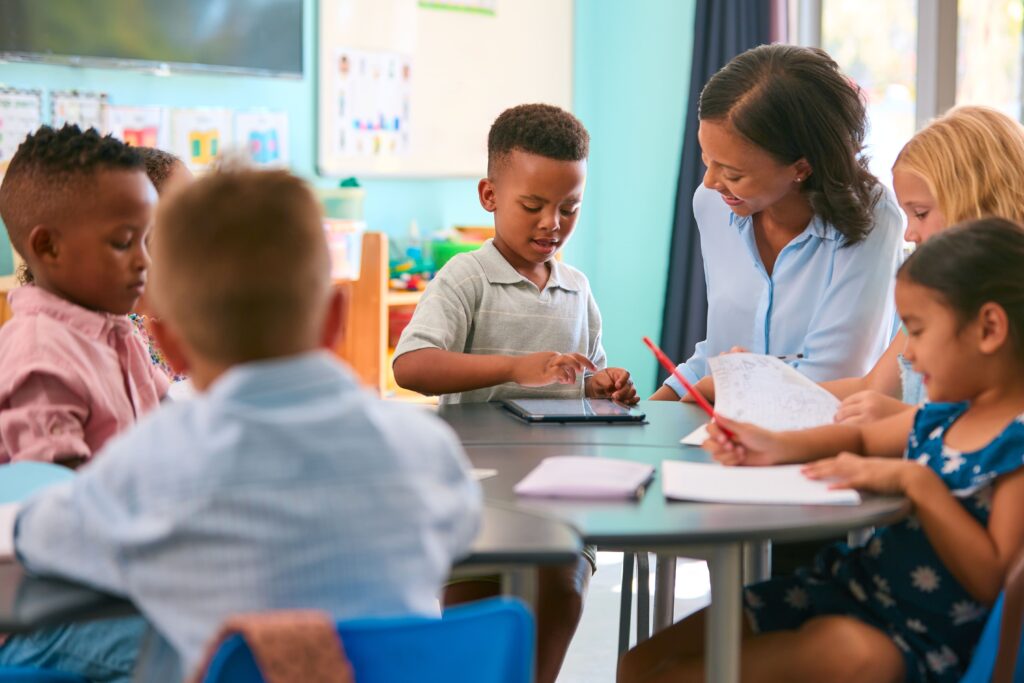 Elementary student working with teacher.