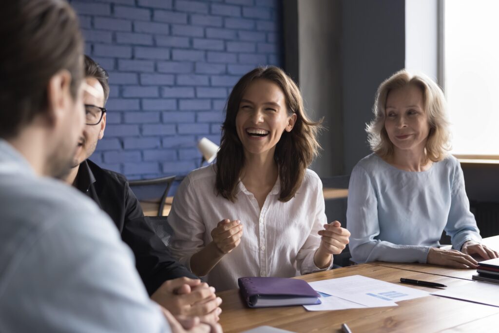 Teachers talking together at a table.