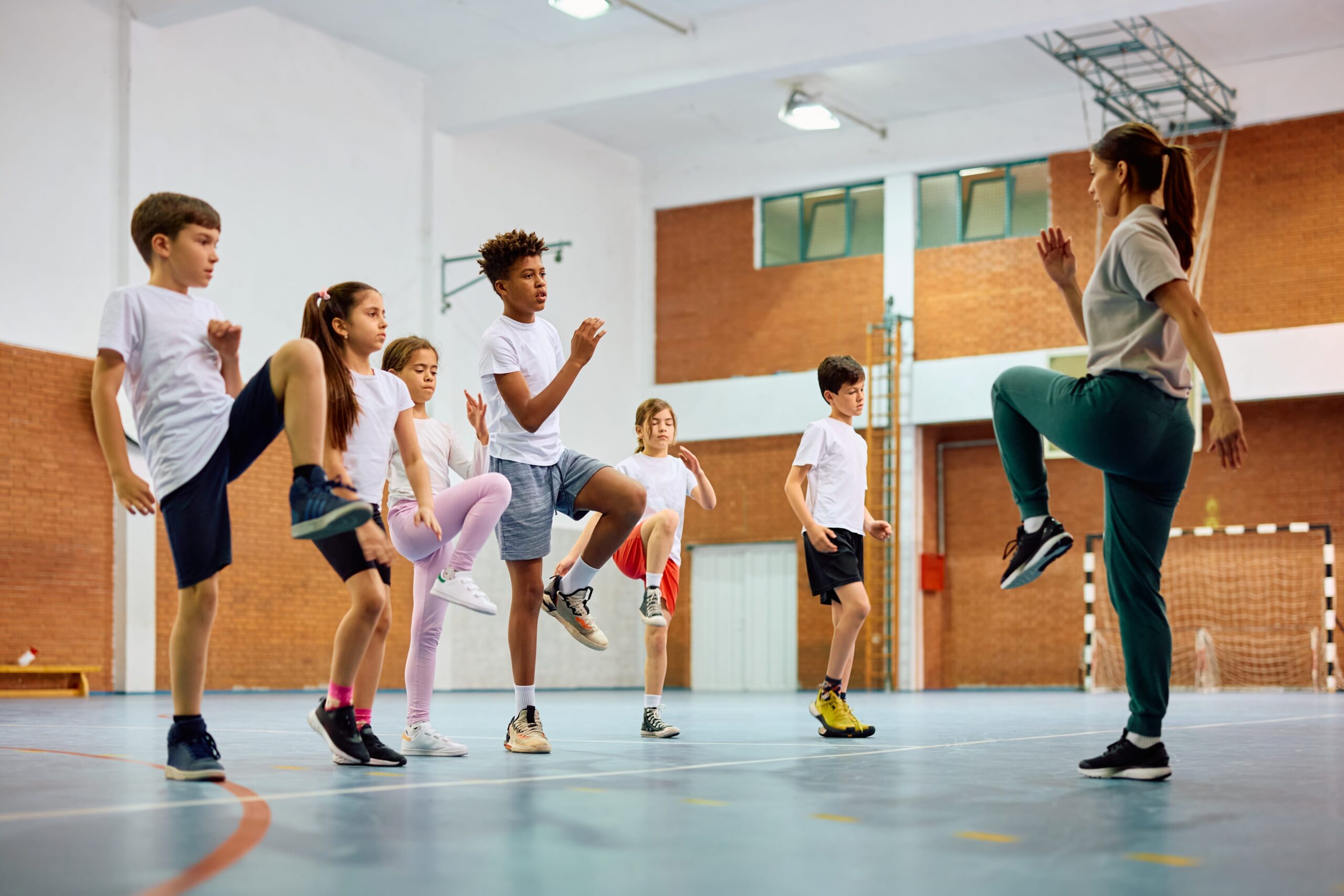 Teacher leading students in fitness activities.
