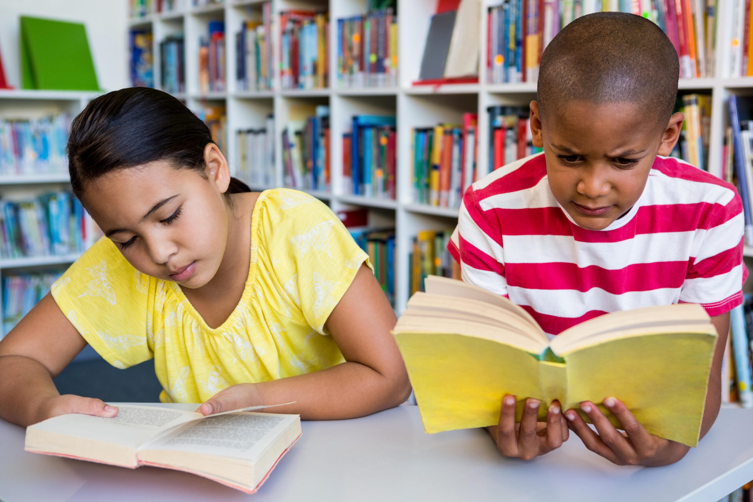 Two students reading independently in class.