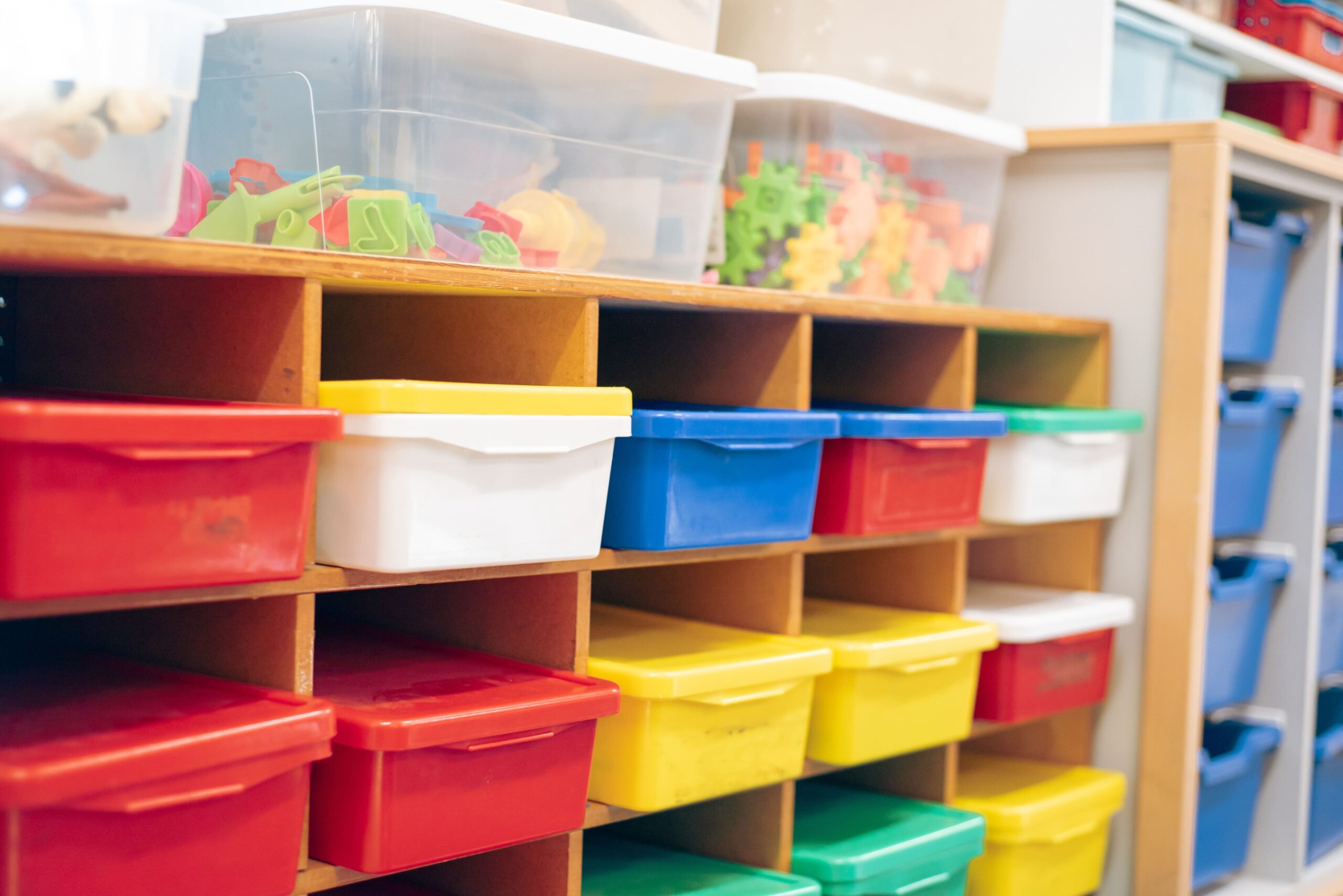 Color coded plastic bins used for classroom organization.