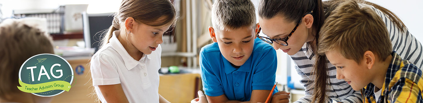 A group of students being helped by their teacher, advertising the TAG (Teacher Advisors Group).